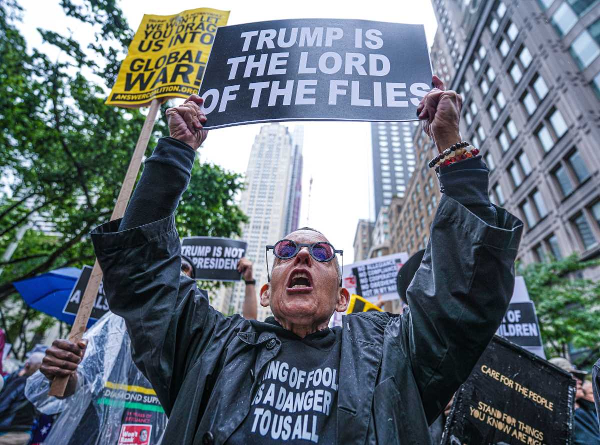 NO KINGS DAY: Tens of thousands hit NYC streets to protest Trump, autocracy and deportations 5 Person holds sign during No Kings Day march
