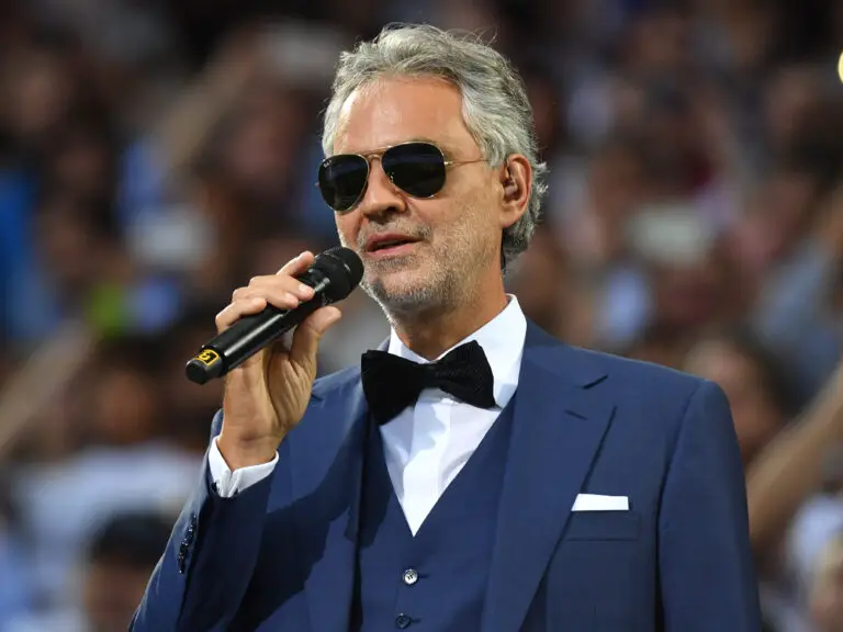 Andrea Bocelli playing with a blue tuxedo