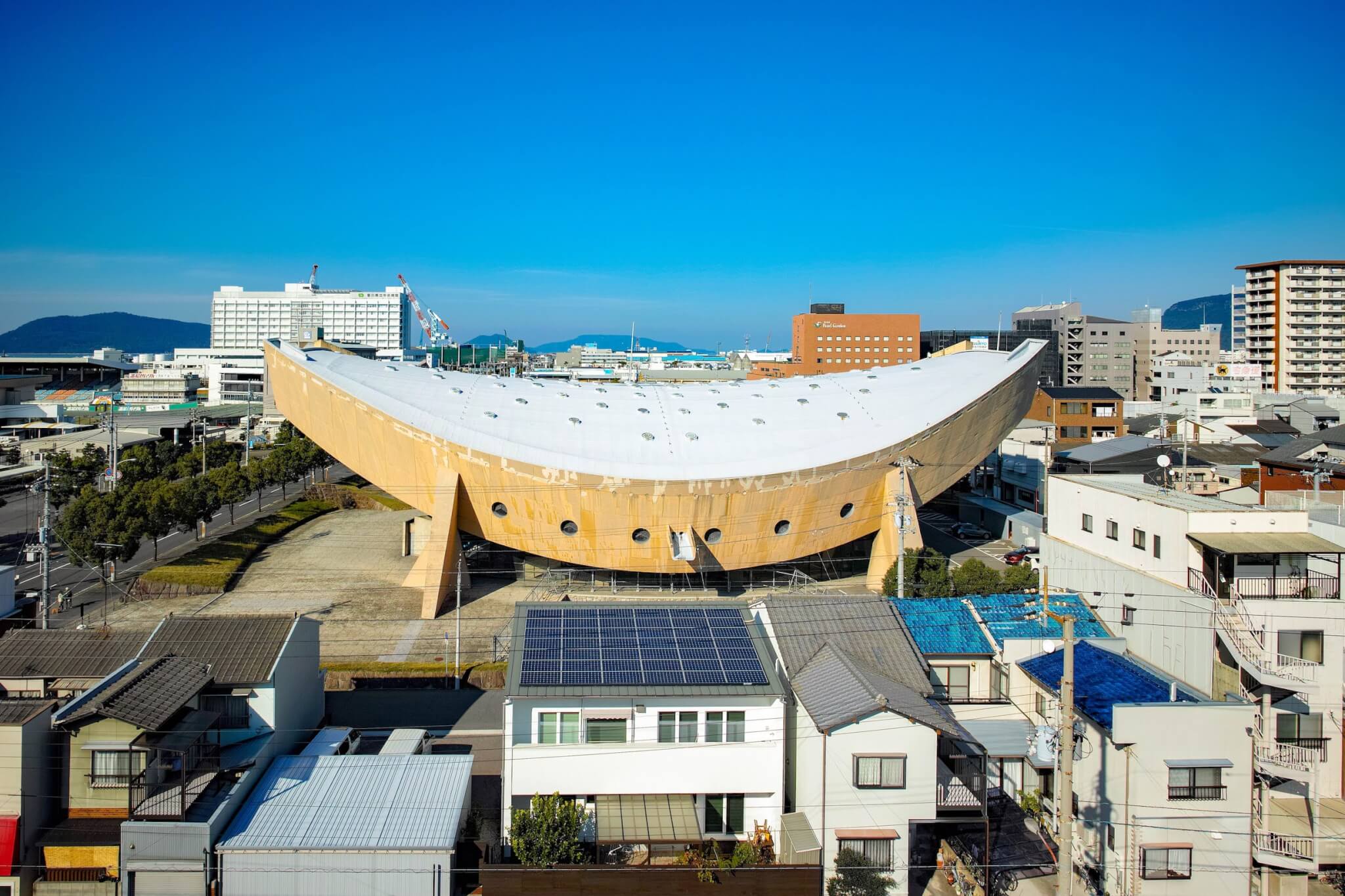 an exterior of the sloping gymnasium roof, remnant of Japanese wooden boats