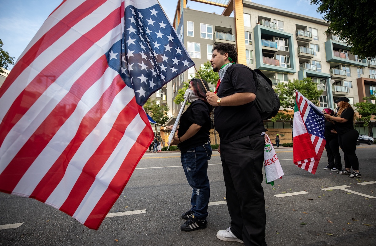 Two protesters carrying U.S. flags  during the 