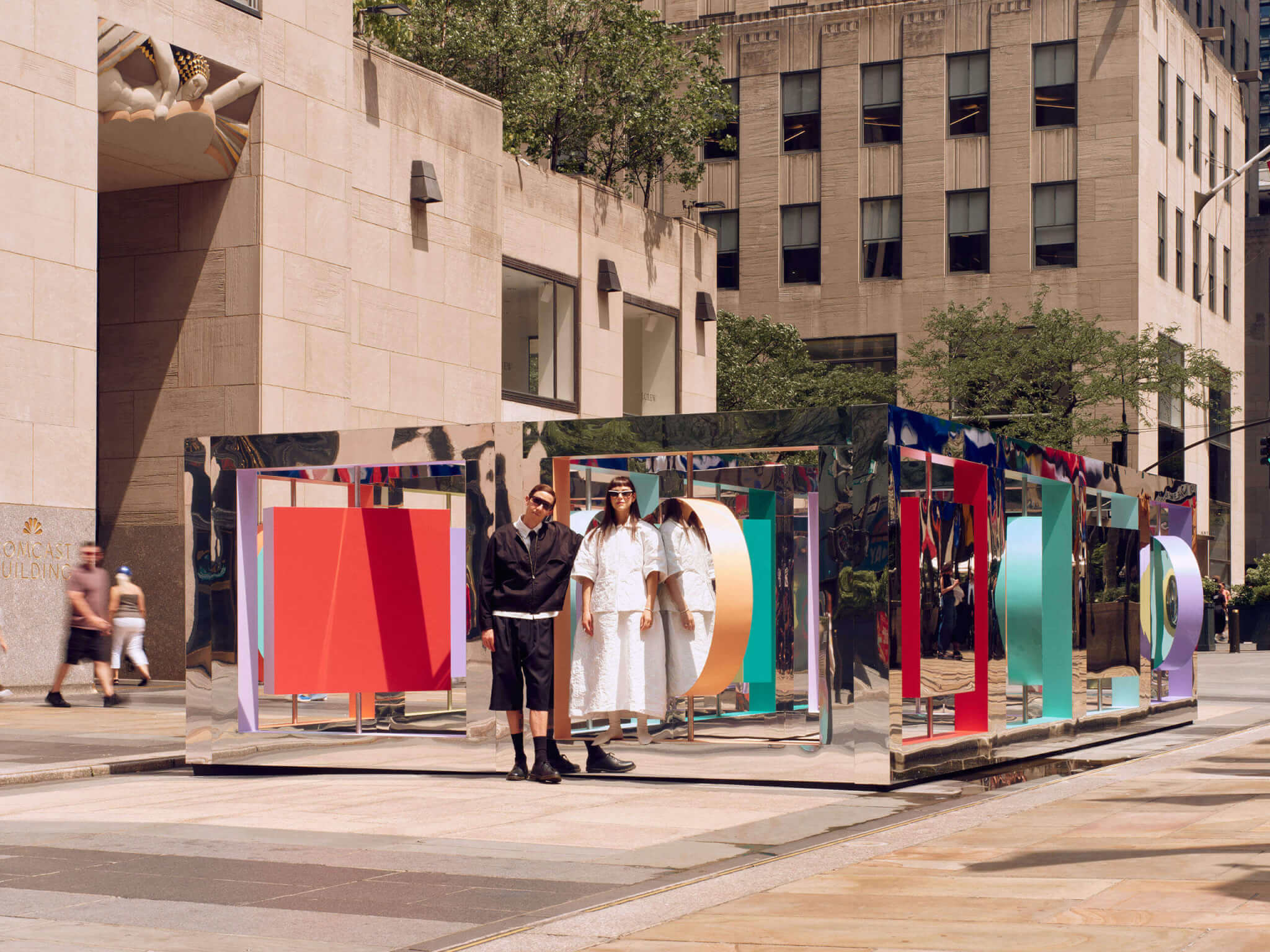 To people standing in front of art installation