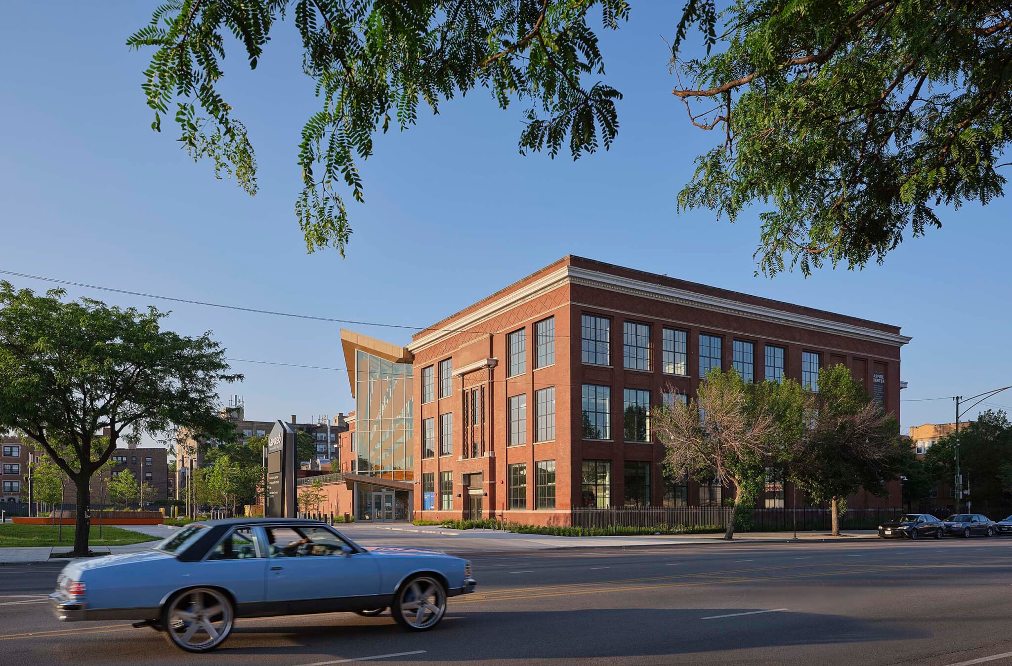 view of masonry brick building with glass atrium