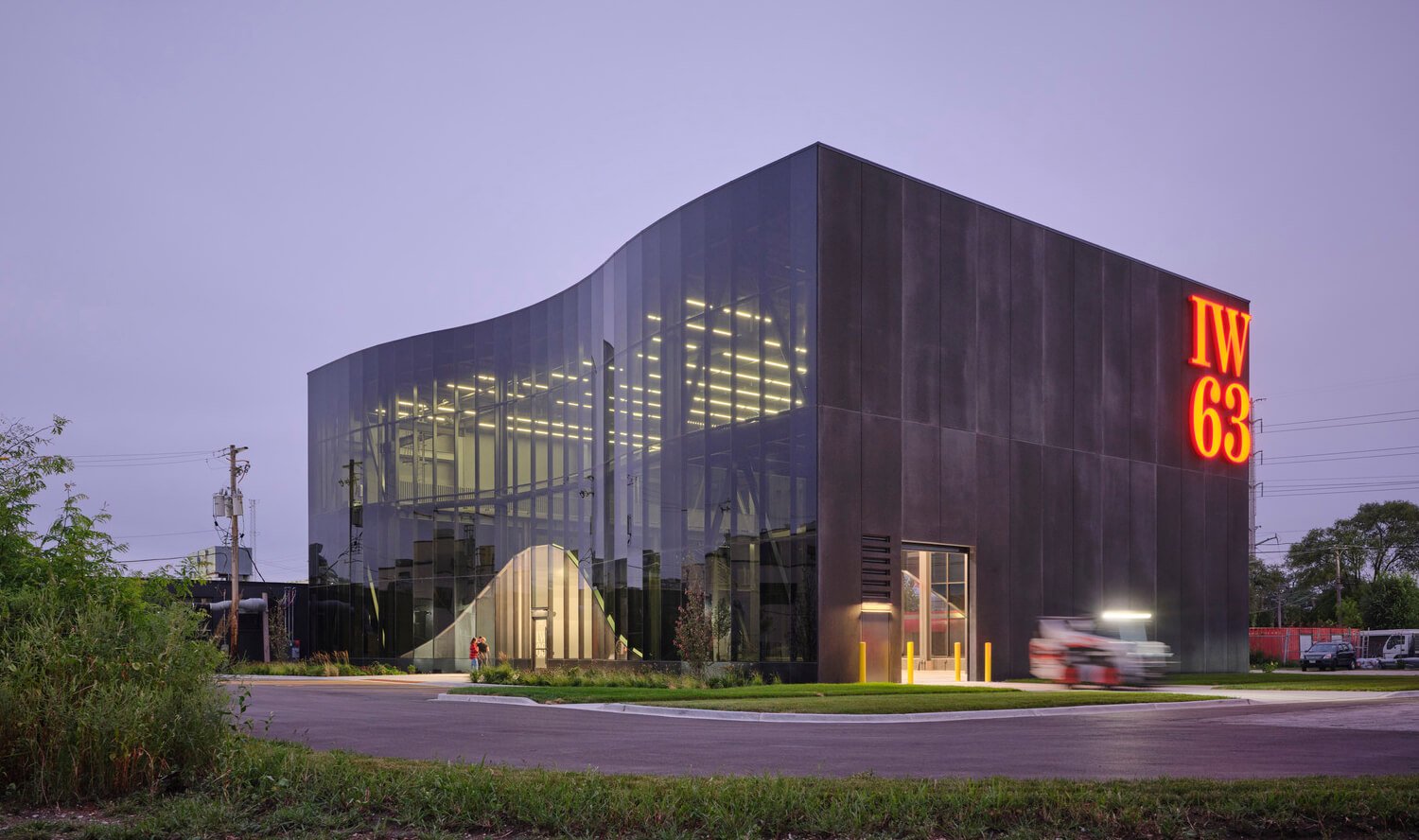 dark tinted curtain wall, black concrete panels, ironworkers 63