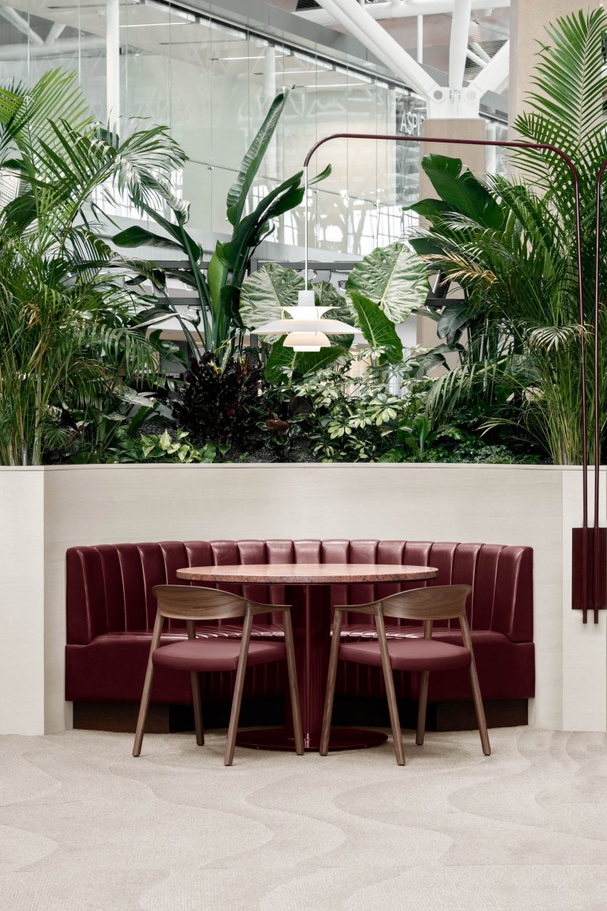 Booth featuring oxblood-coloured leather seats, tables and dining chairs