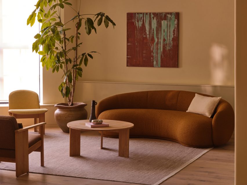 Colourful artwork above rounded sofa