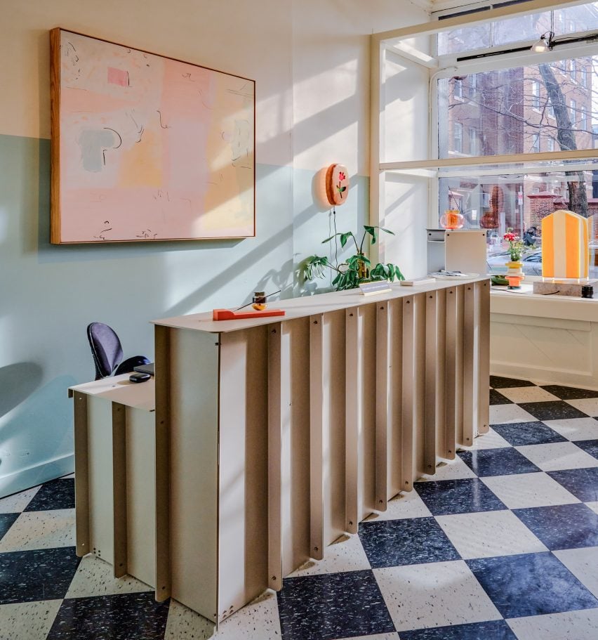 Plywood reception desk on a checkerboard floor