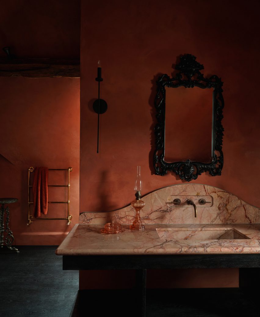 Terracotta-toned bathroom in UK farmhouse