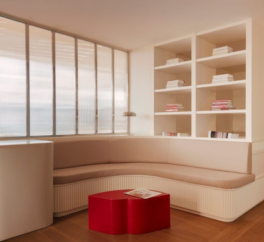 Spa waiting area located behind chrome-framed, fluted-glass panels