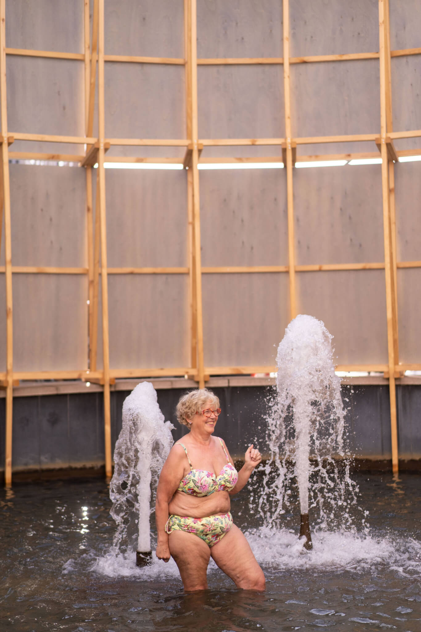 Woman bathing in art installation with a dipping pool