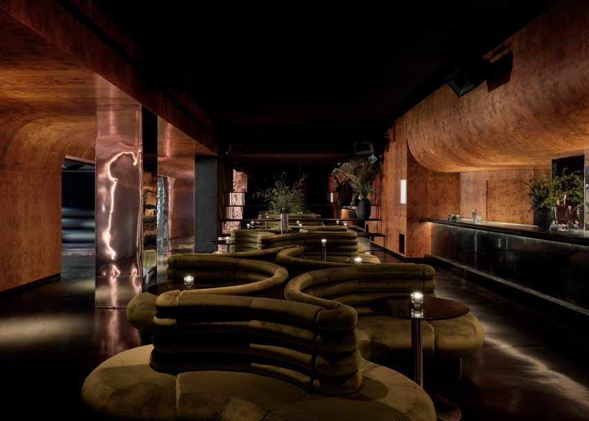 Custom velvet-upholstered seats linked together in groups of five