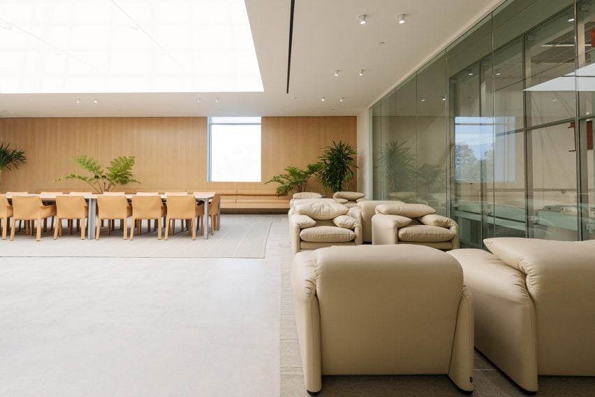 Photo of the SkyLab lounge at Vast's headquarters showing plush leather armchairs, a wood-panelled back wall, and a glass internal wall allowing views into the workplace