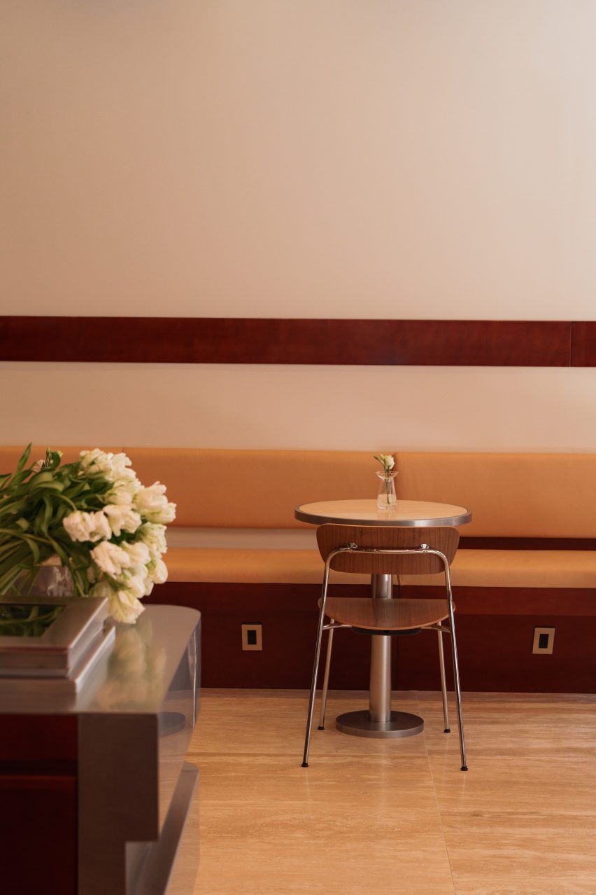 Chair and cafe table in front of a caramel-toned banquette