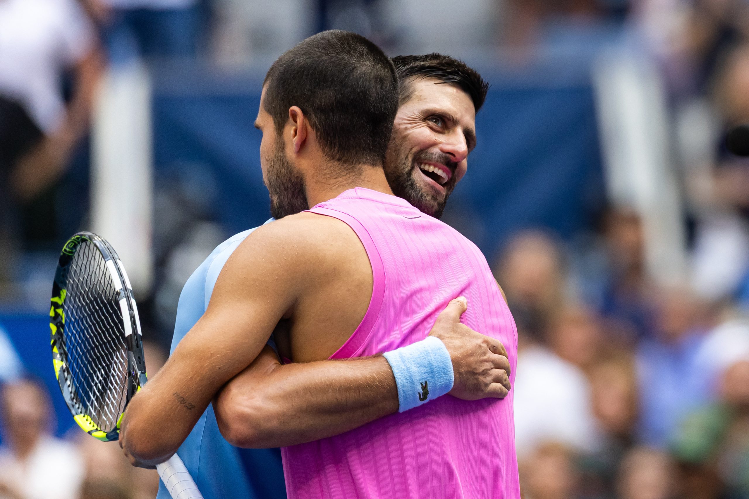Sep 5, 2025; Flushing, NY, USA; Carlos Alcaraz of Spain and Novak Djokovic of Serbia embraces after their match in the semifinal of the mens singles at the US Open at Arthur Ashe Stadium in Billie Jean King National Tennis Center. Mandatory Credit: Mike Frey-Imagn Images