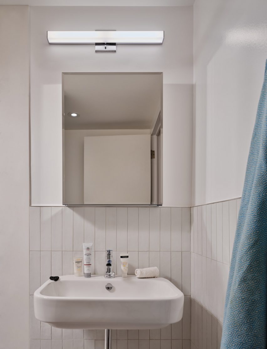 Bathroom sink with a mirror and a light above