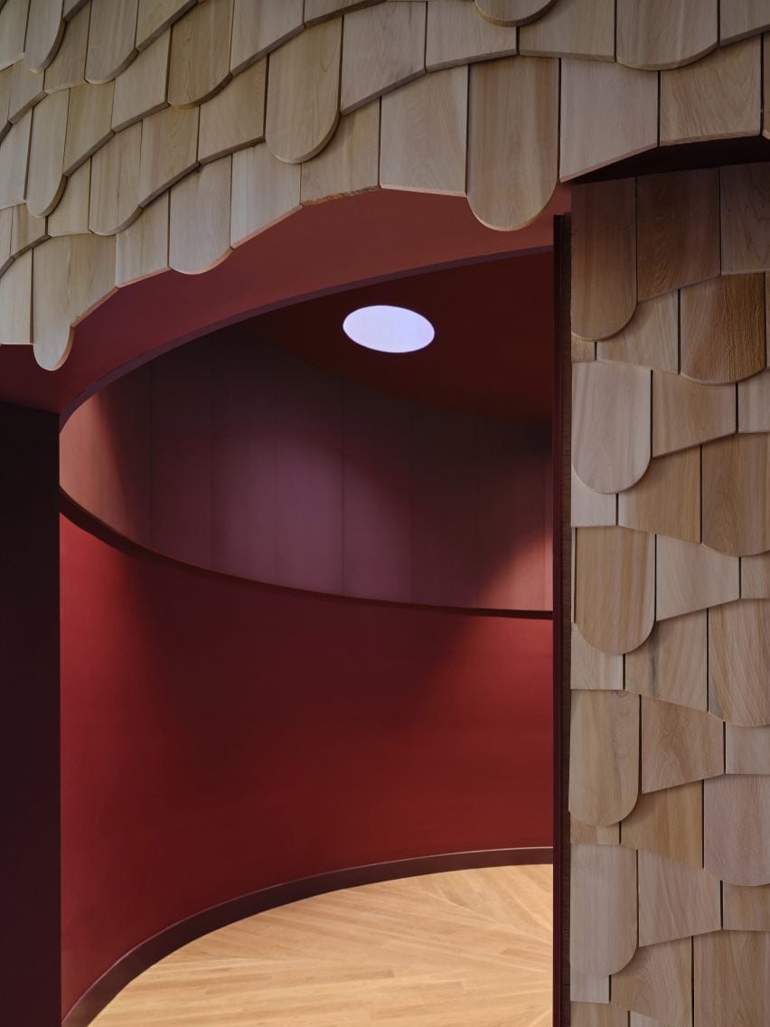 A shingle-clad circular room with a deep red interior