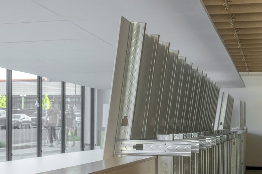 Steel structure supporting white wall gallery space