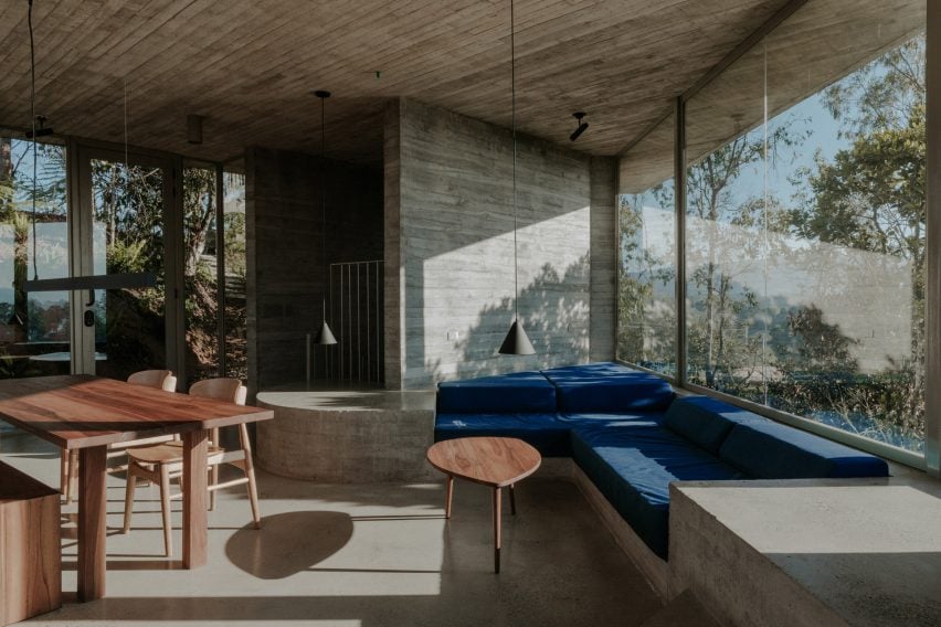 Living room with concrete walls and ceiling and built-in sofa