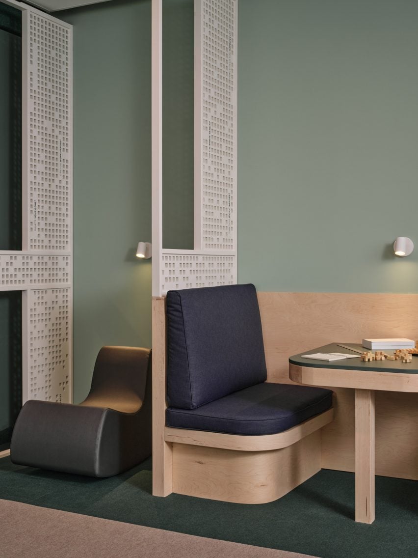 Rocking chair and a banquette seat against a pale green wall