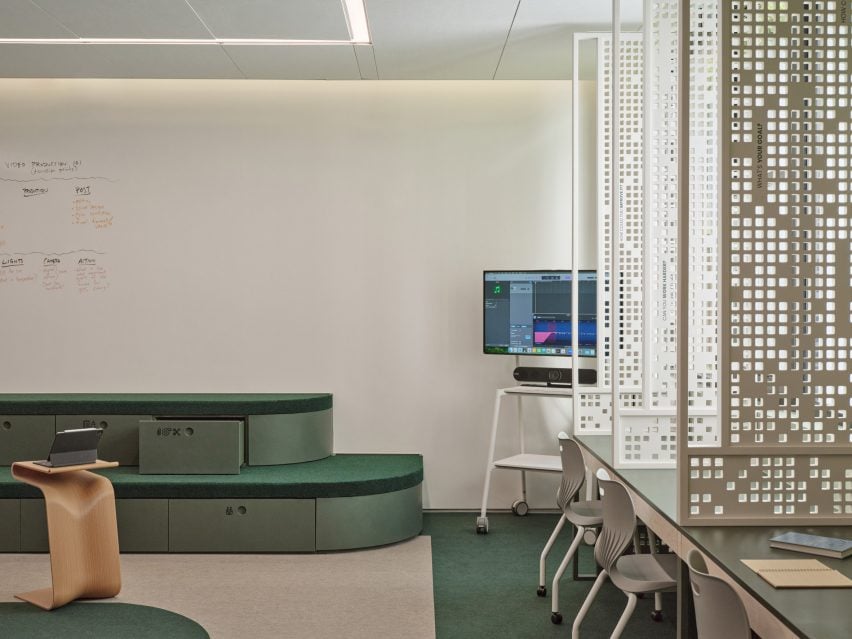 Classroom with green bleachers and white furniture on wheels
