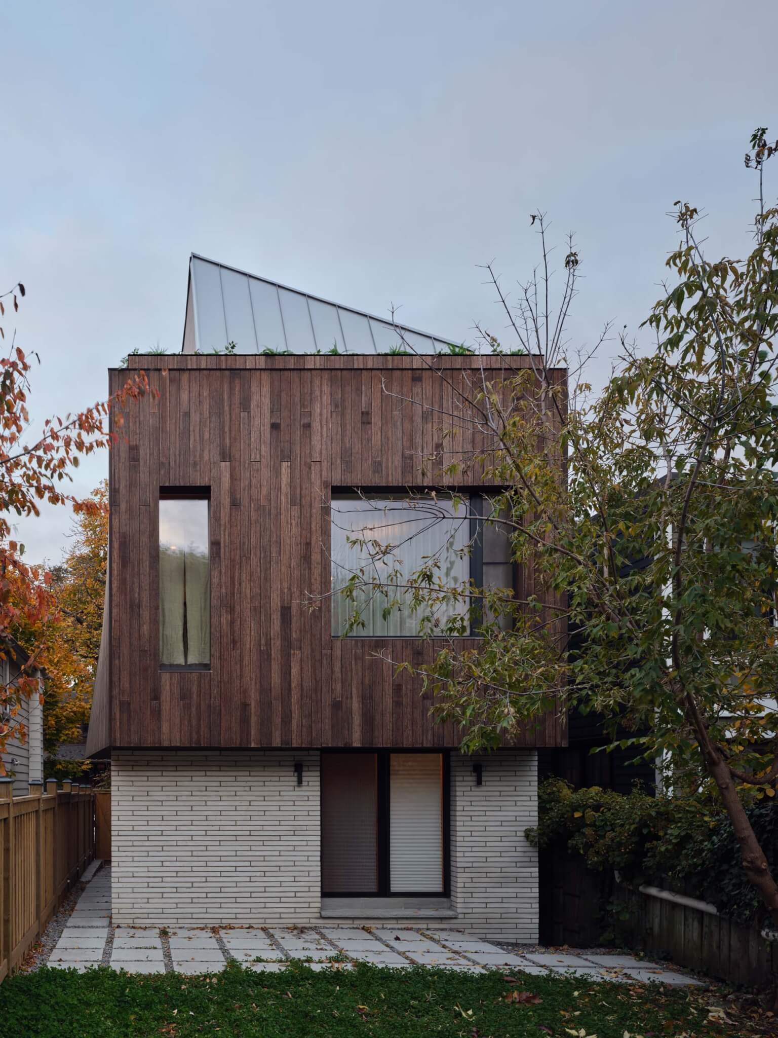 house with wood and brick cladding by EDGZ Architecture & Design