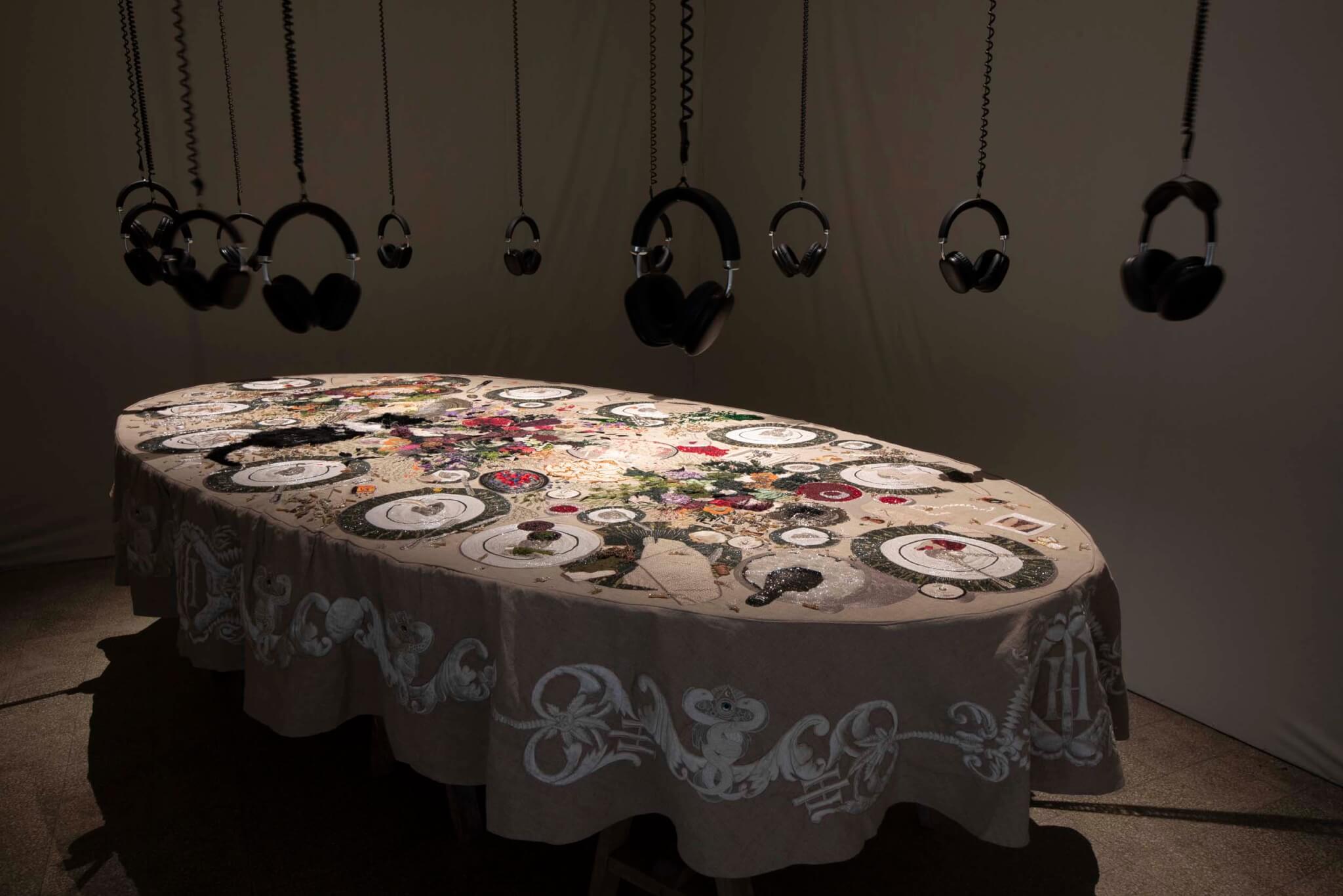 tablecloth with headphones dangling above it 