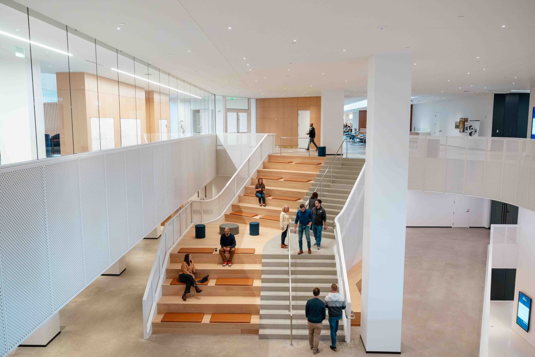 Large interior staircase populated with staff