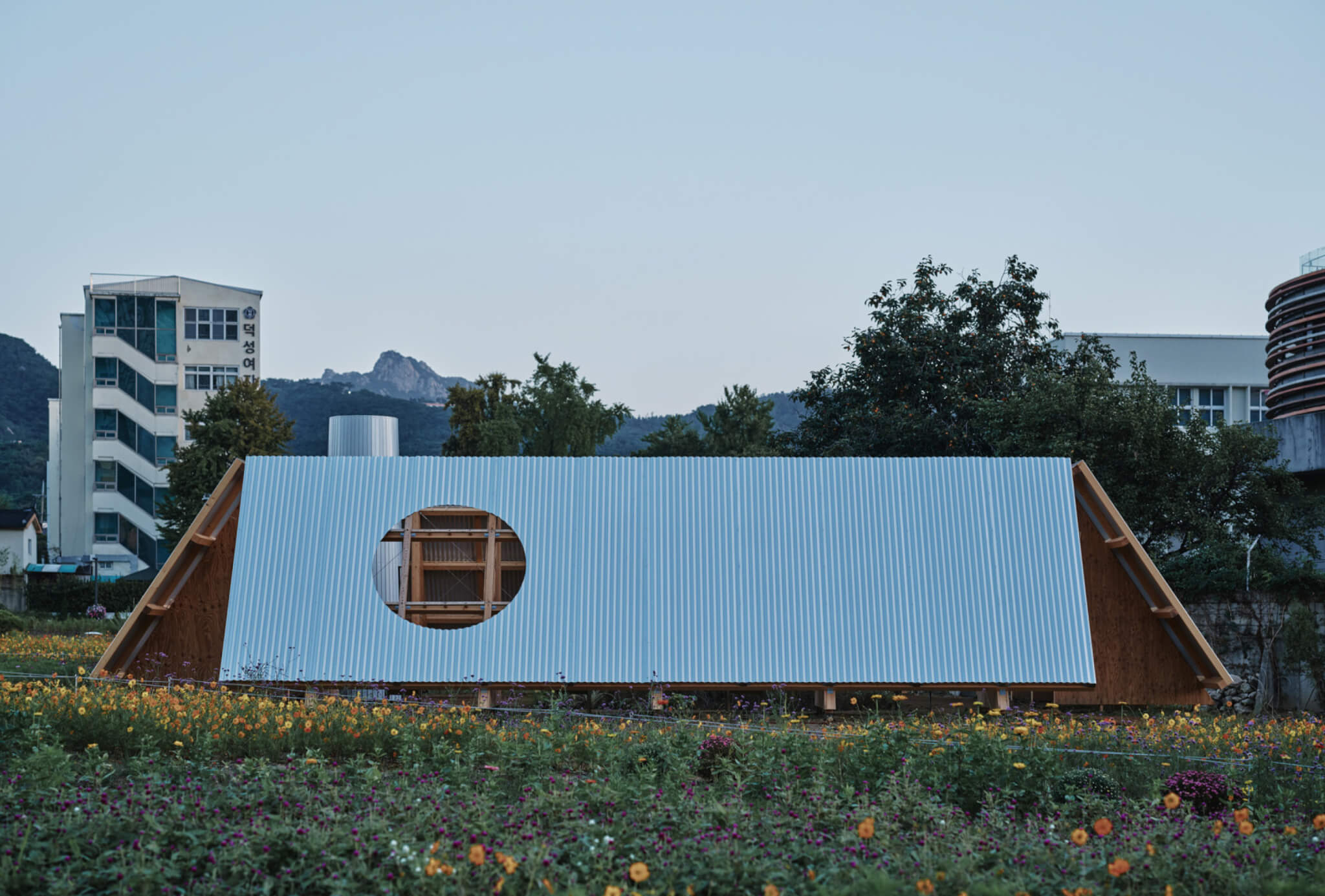pavilion with slanted walls in a field