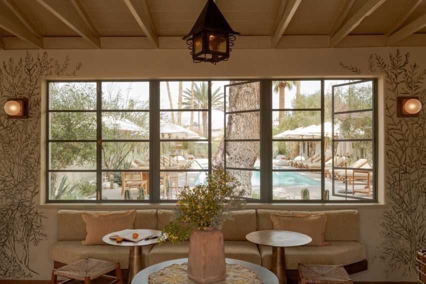 A mural by artist Kim Swift recreates desert flora on a lobby's cream walls