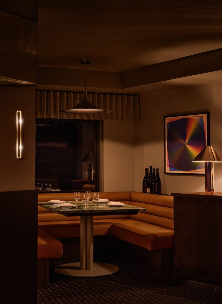 A single group table topped with green marble tucked into a corner