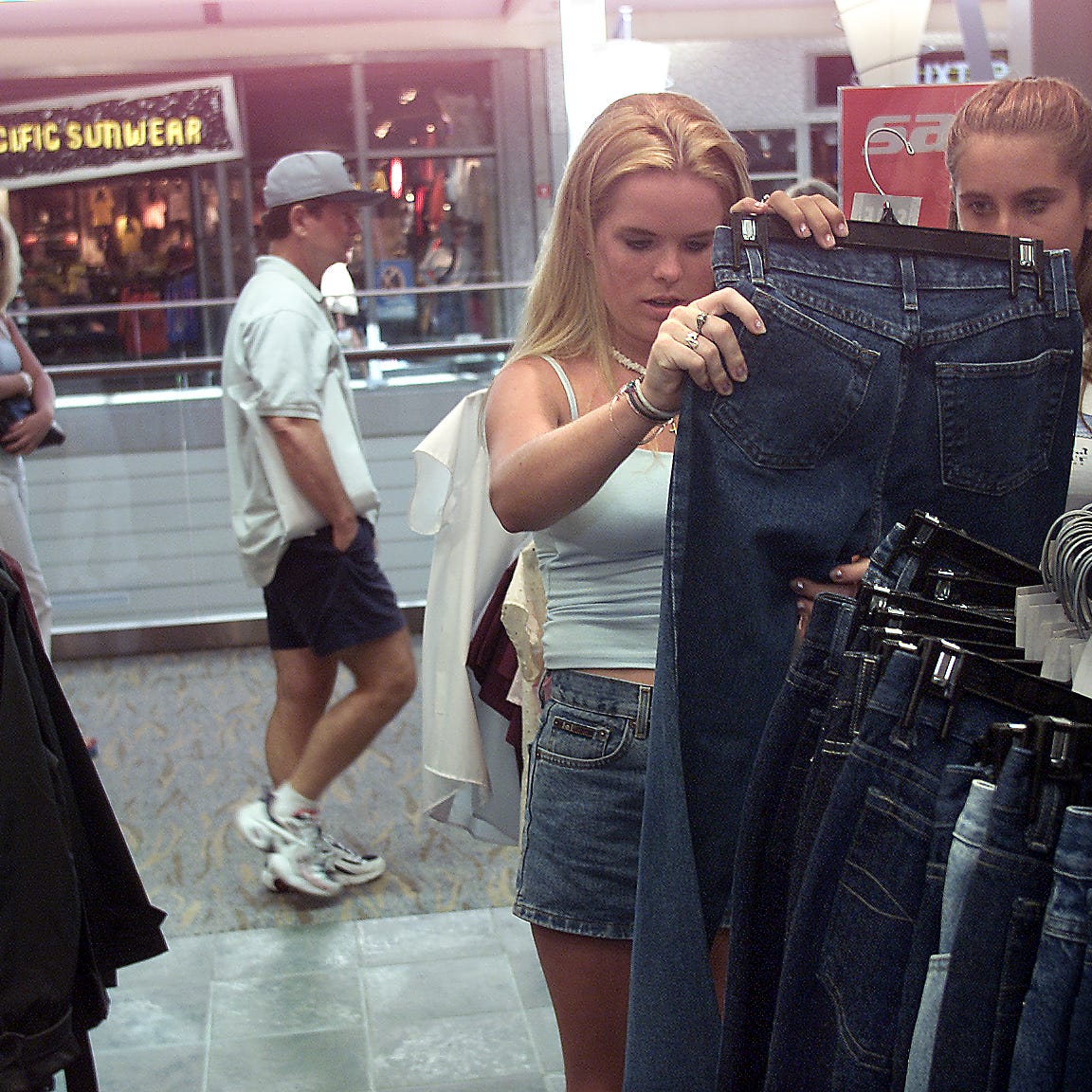 Erin Dwyer, 16, left, and Lauren Semchenko, 15, shop for clothes inside Rave stoe located inside Pac erin dwyer, 16, left, and lauren semchenko, 15, shop for clothes inside rave stoe located inside pac