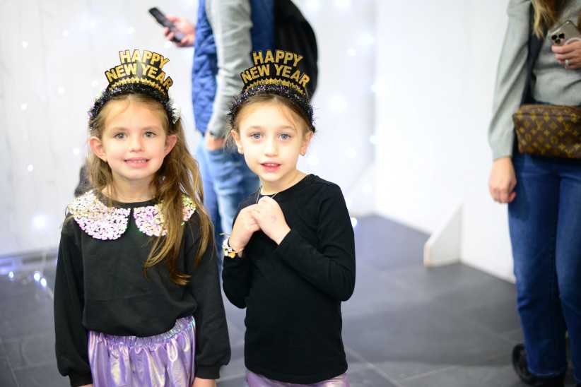 two young girls wearing black and gold 