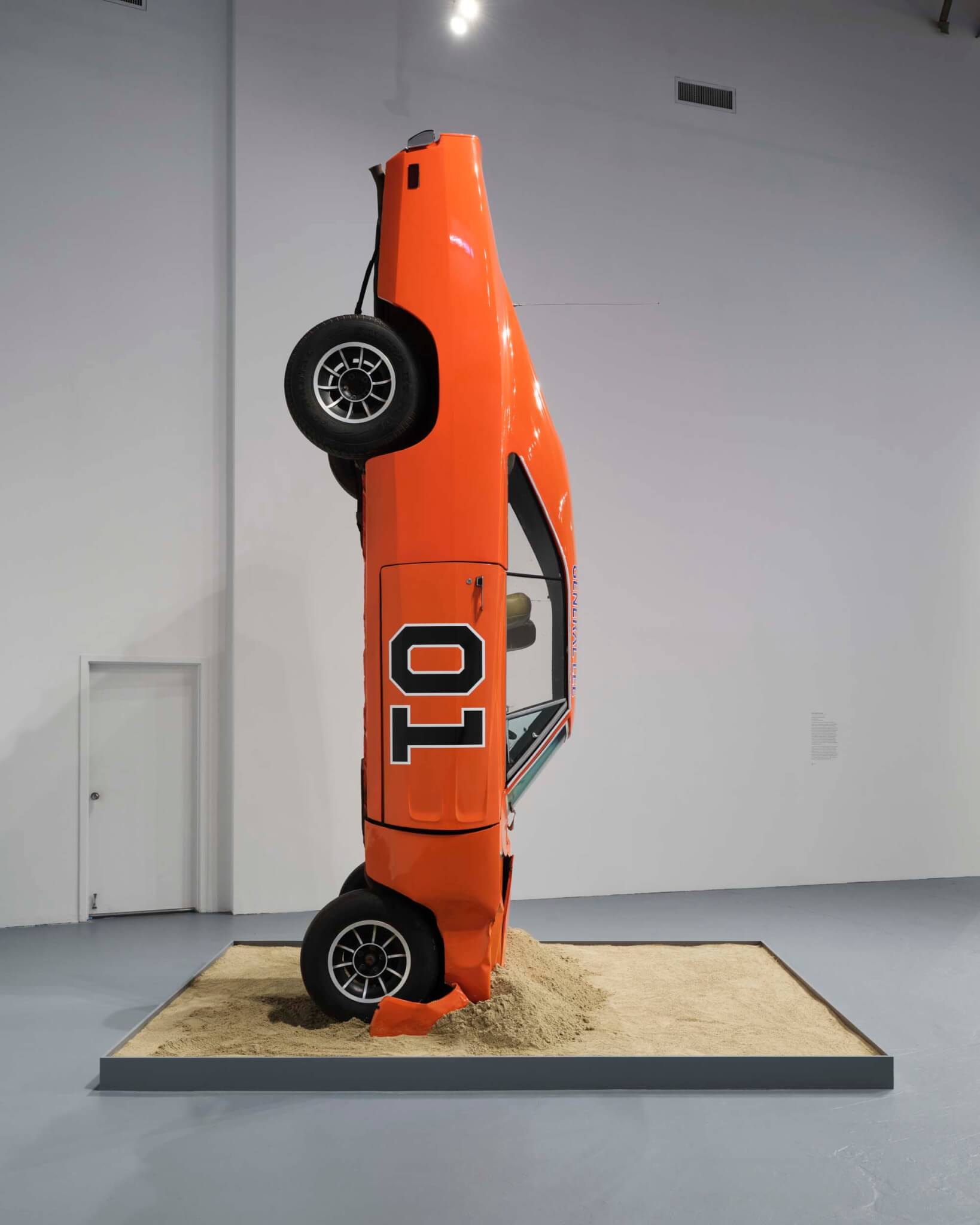 orange car in art gallery