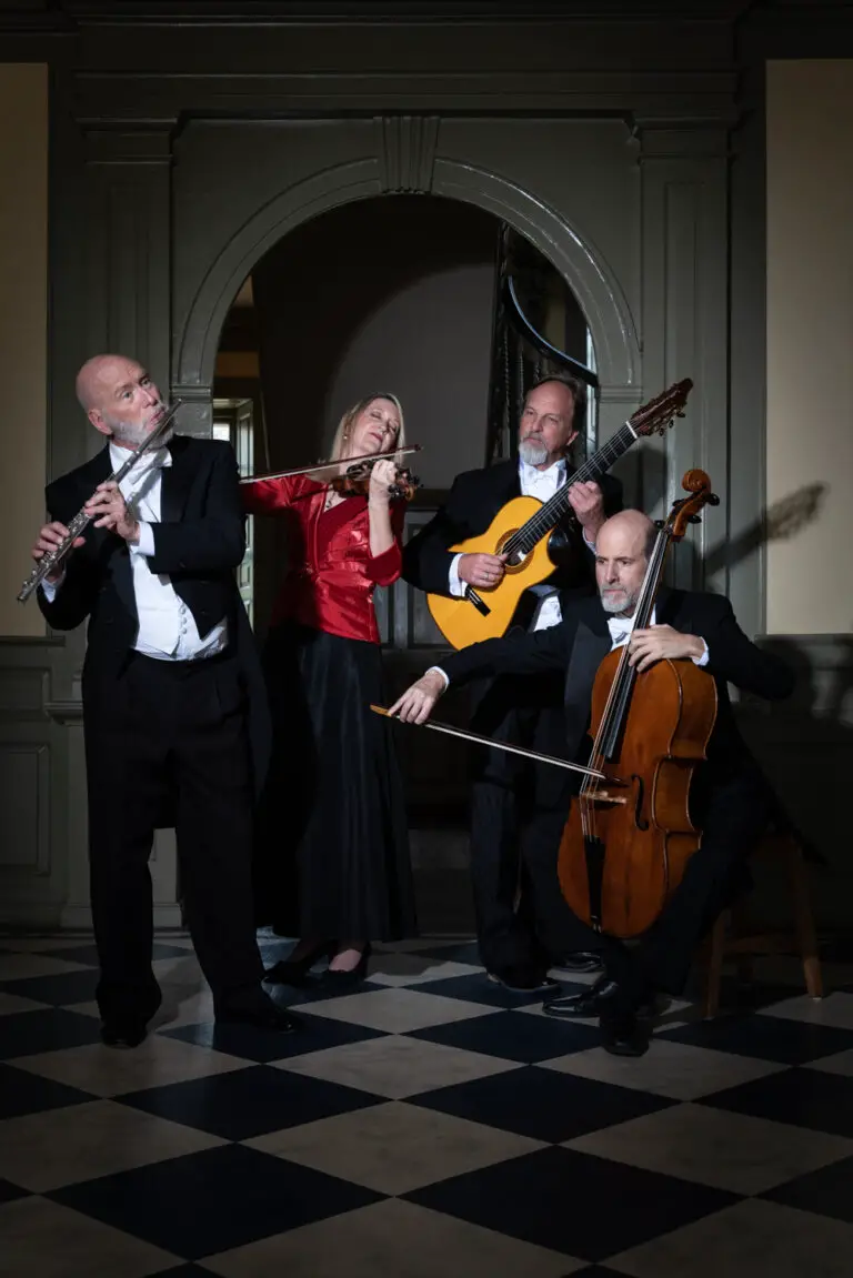 Four musicians holding a flute, a violin, a guitar and a cello from left to right.