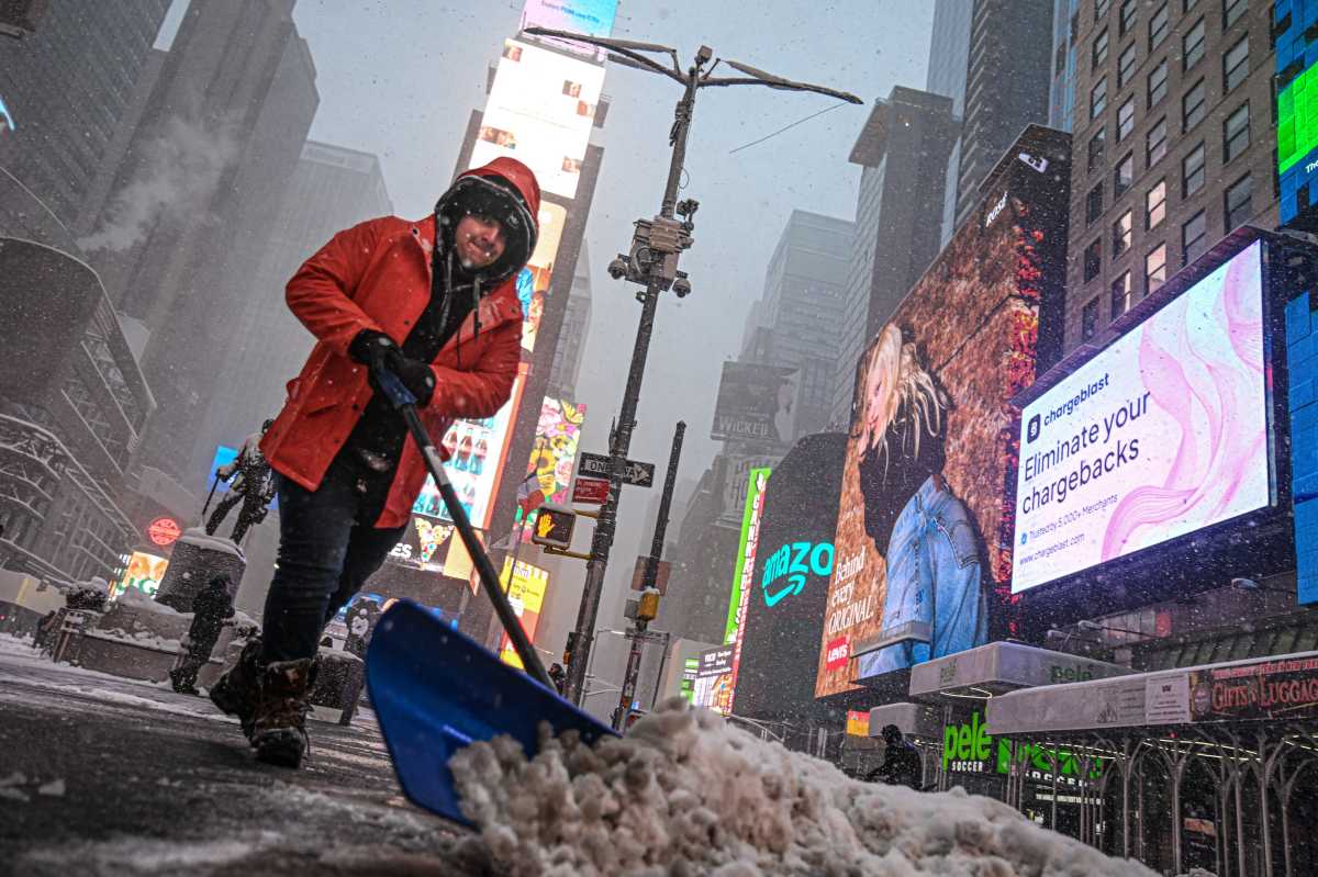 new yorker shovels snow during blizzard amid mamdani's first 100 days in office