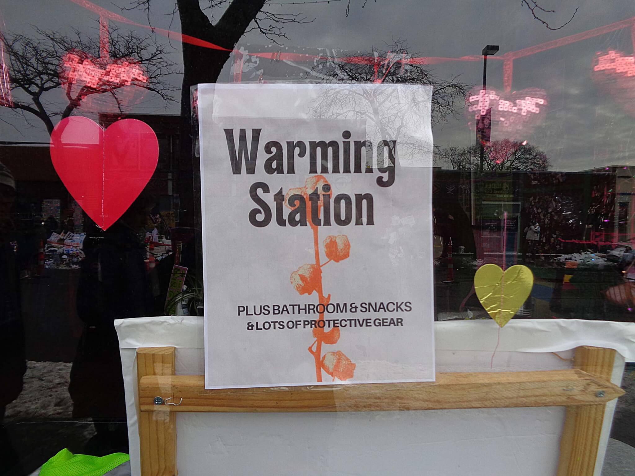 sign in window of minneapolis business reading warming station