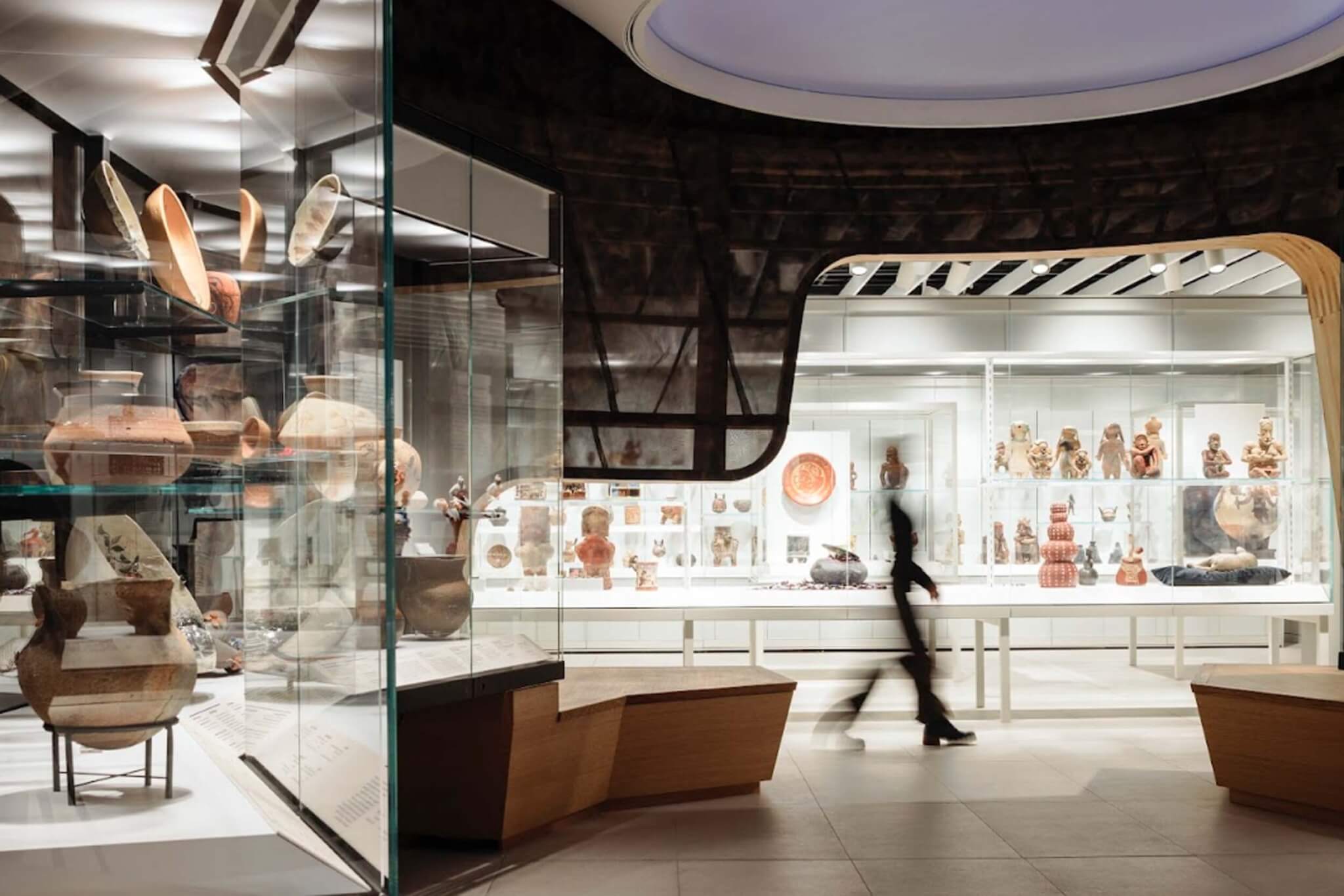 ceramic objects on display behind glass.