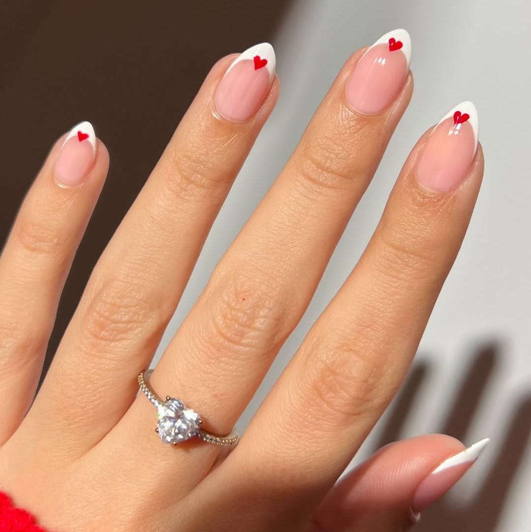 manicure featuring hearts and a ring