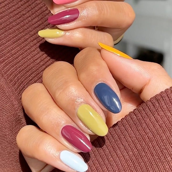 colorful nail art displayed on hands