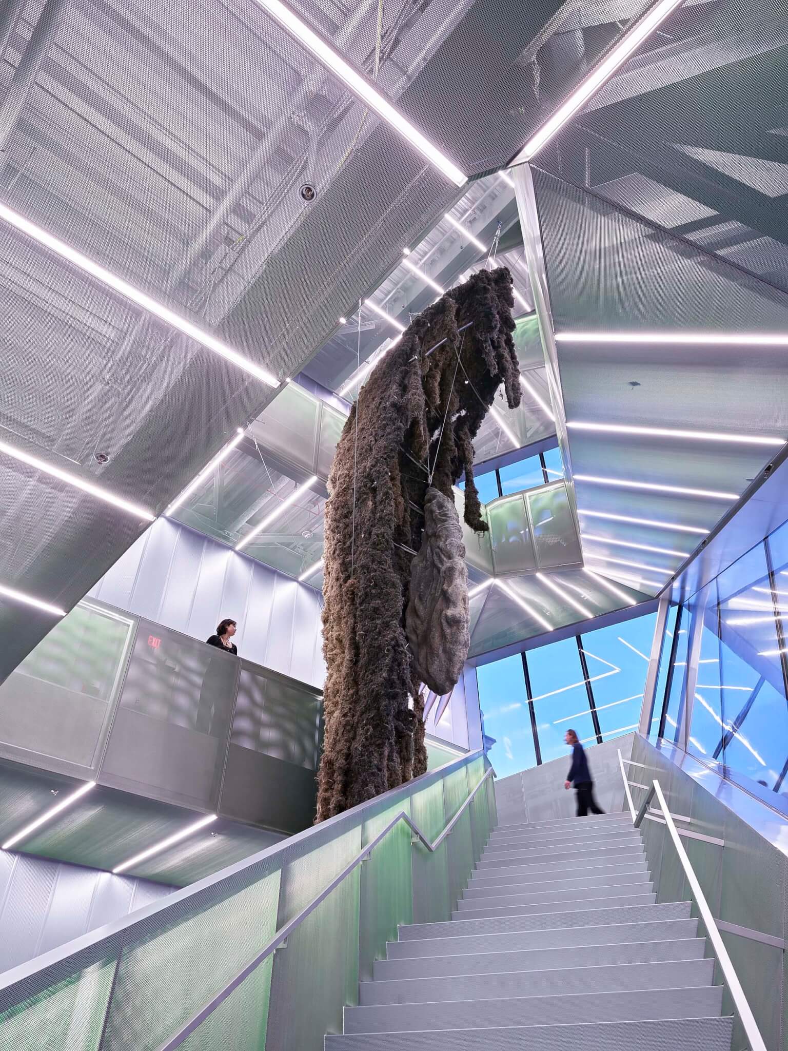 interior of new museum showing staircase with mesh and green railings